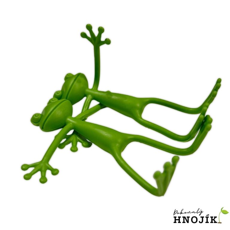 Zwei grüne Froschfiguren, die nebeneinander liegen